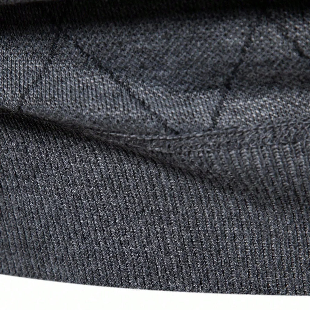Dark gray knit sweater fabric close-up with ribbed collar and thick stitched texture