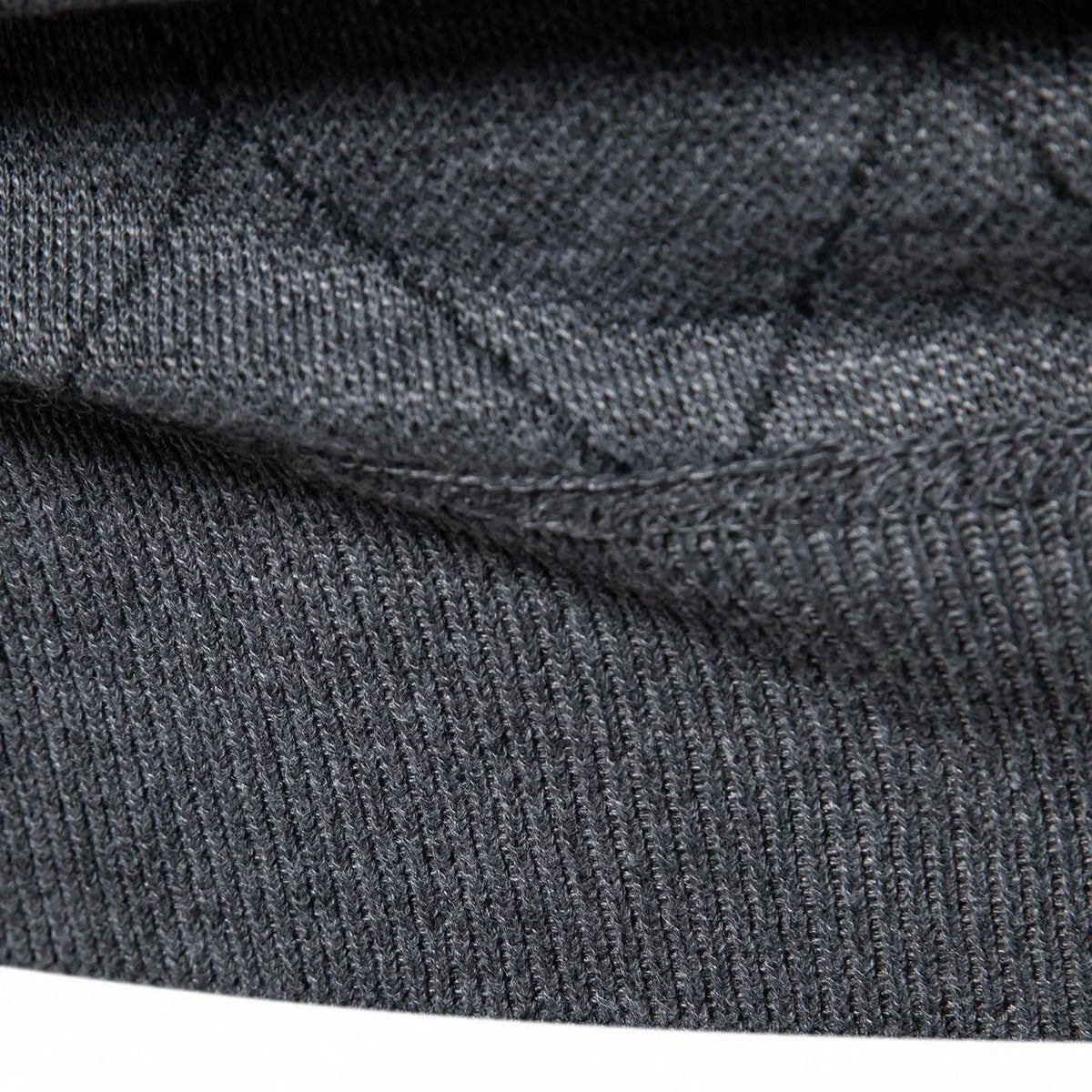 Dark gray knit sweater fabric close-up with ribbed collar and thick stitched texture
