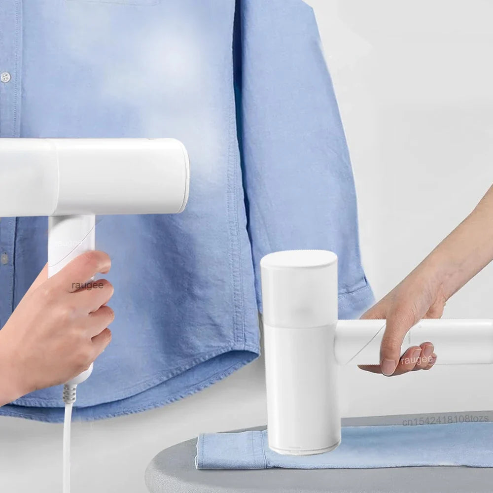 Handheld garment steamer releasing steam onto a blue shirt sleeve