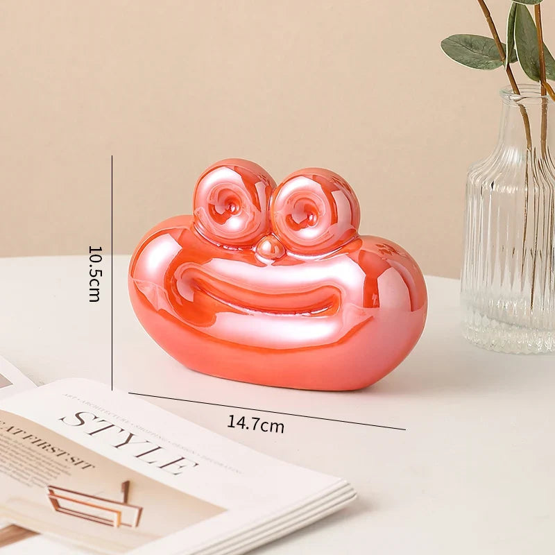 Red glossy ceramic sausage-shaped decorative ornament with cute face detail