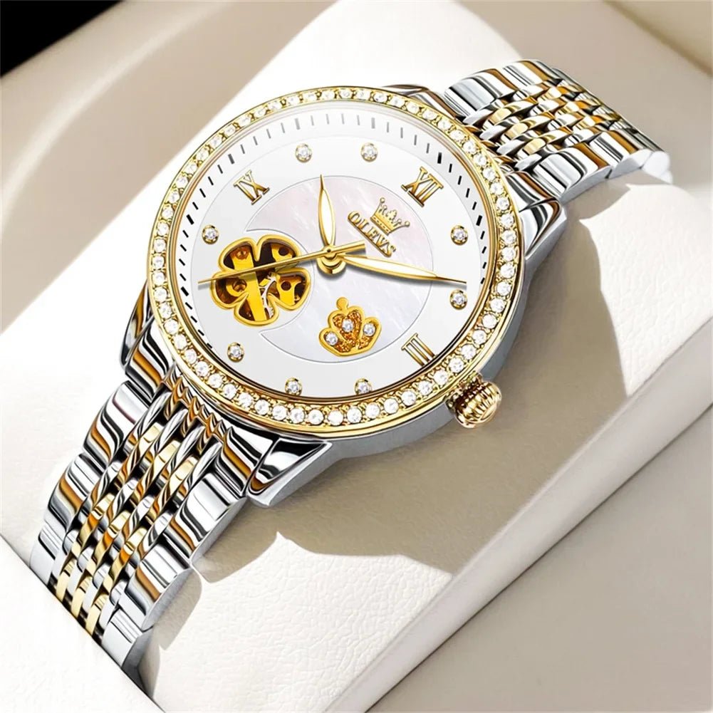 Two-tone automatic bracelet watch with white floral dial, gold hands, rhinestone bezel
