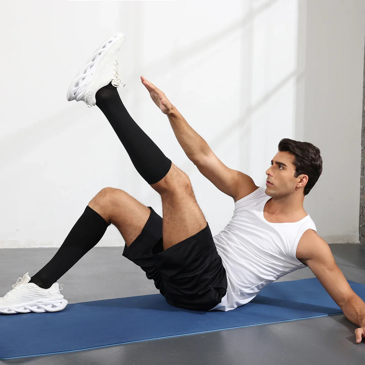Black knee-high compression socks on legs, ribbed knit over the calf