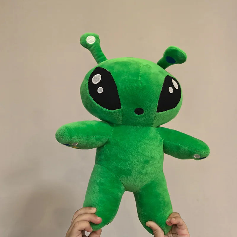 Green alien plush toy standing upright, with horn tentacles and outstretched arms