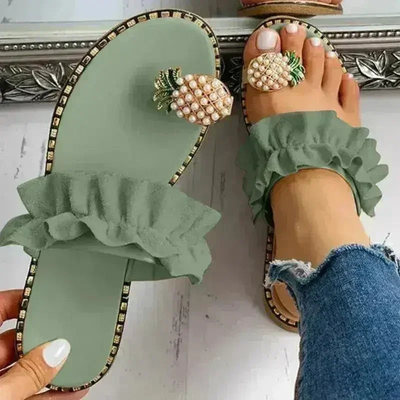 Sage green flat slide sandals with pearl pineapple buckle and layered ruffle