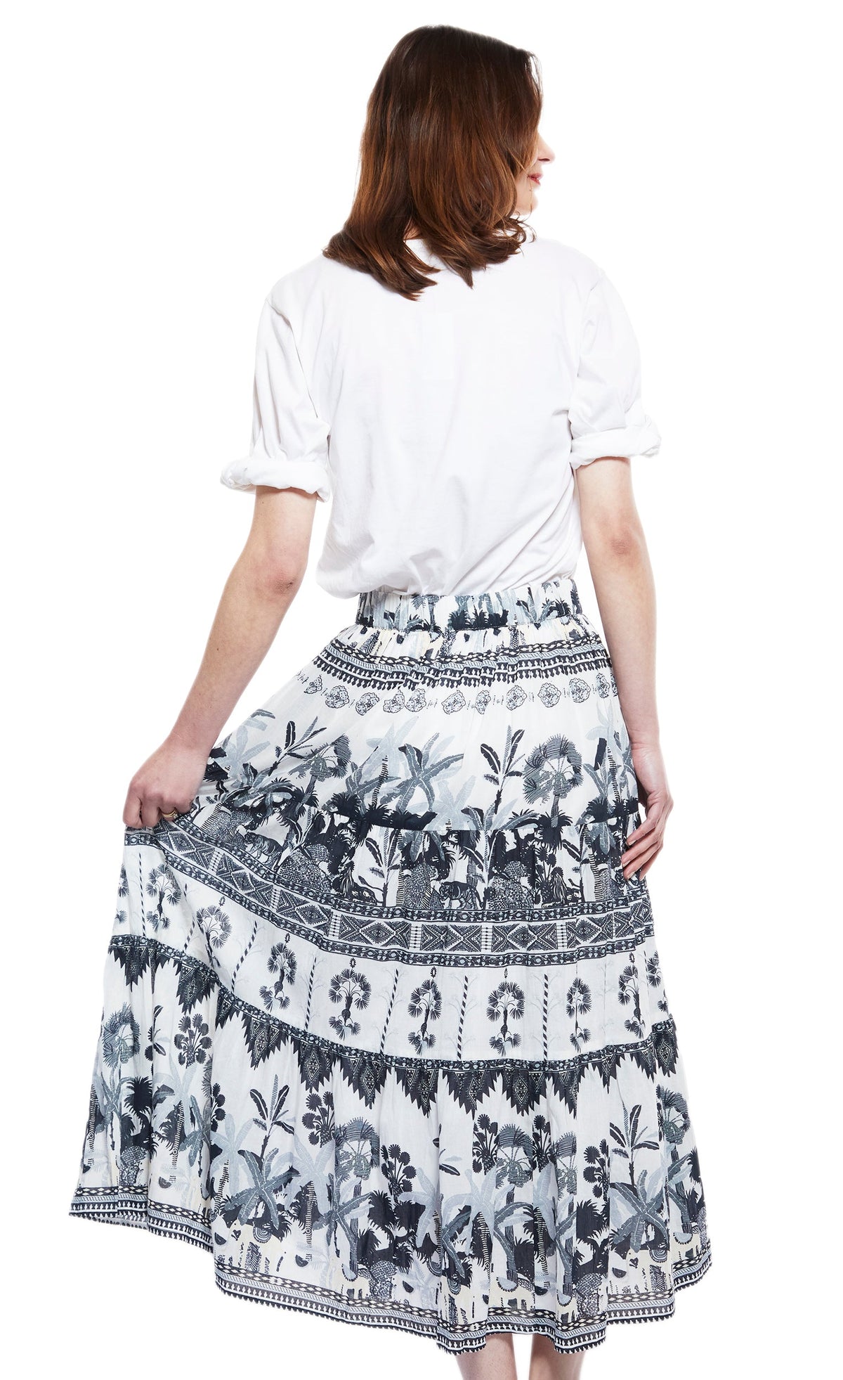 Women's midi skirt back view with blue-grey ikat pattern and tiered ruffle hem