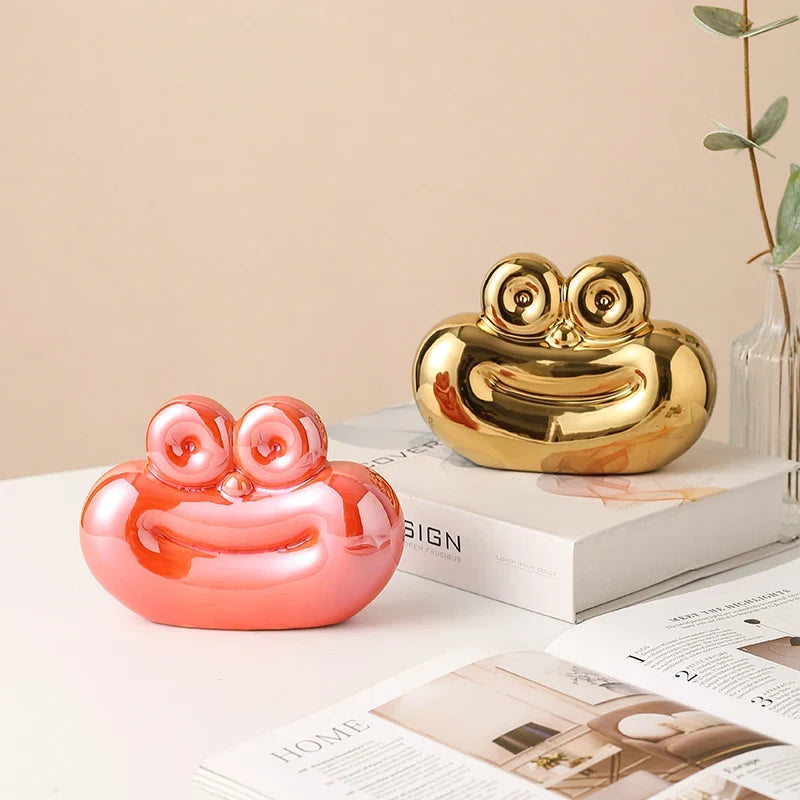 Gold and coral sausage-shaped ceramic decorative ornaments with raised round eyes