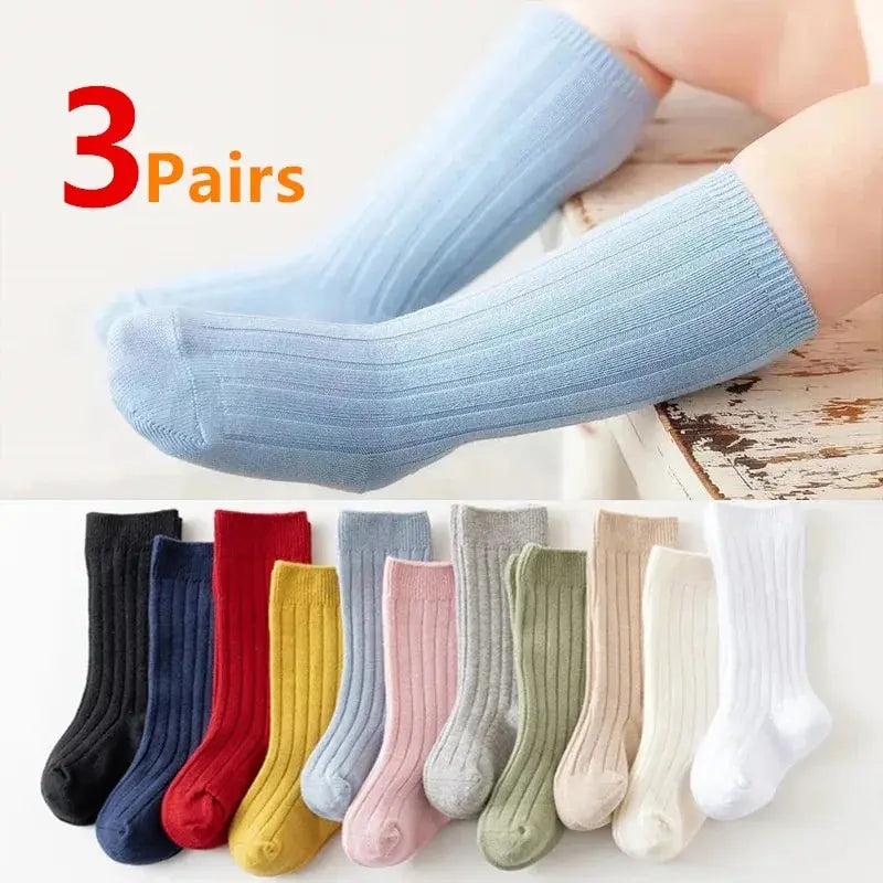 Kids knee-high socks, light blue ribbed cotton with long stripes, on small legs.