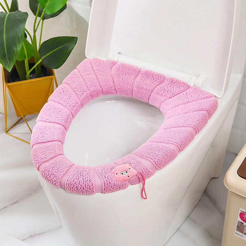 Pink plush toilet seat cover mat with handle, soft looped terry fabric.