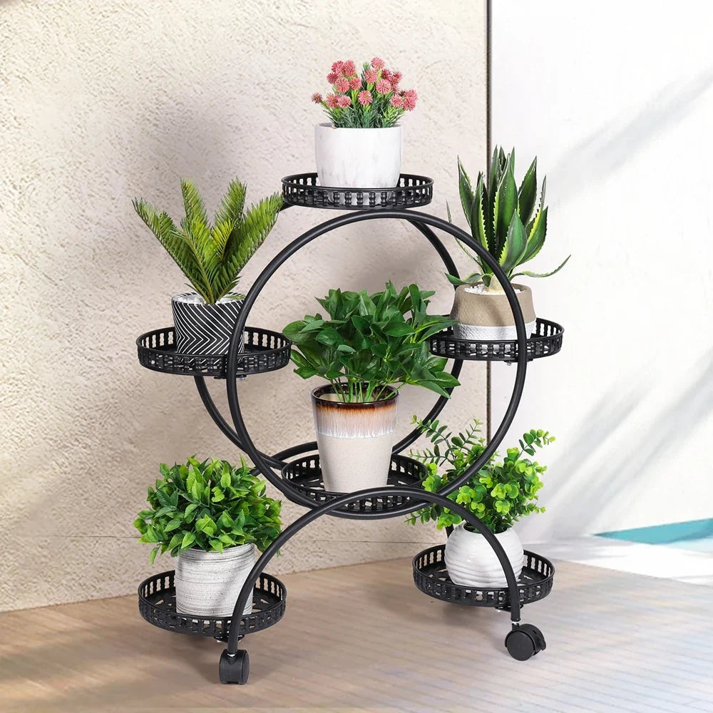 Black metal rolling plant stand with four circular trays on caster wheels