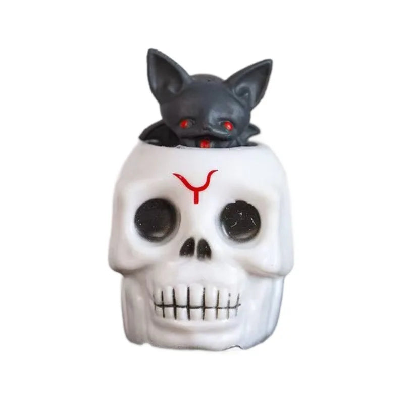 Skull prank toy with black cat head and red horns, white face design
