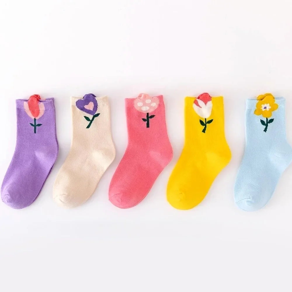 Lineup of five girls crew socks in purple, cream, pink, yellow, and light blue flower prints