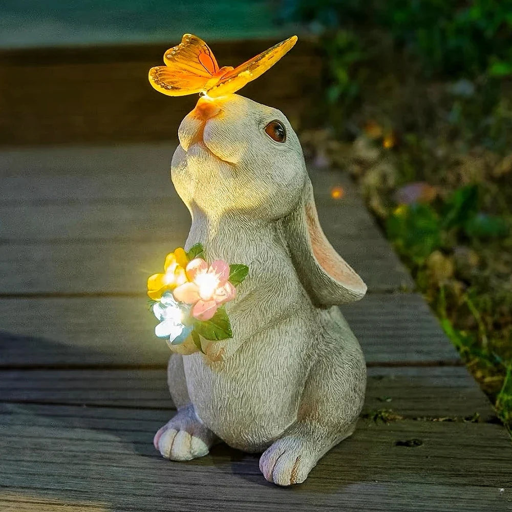 Lighted solar bunny garden statue with golden butterfly and flower bouquet, sitting pose