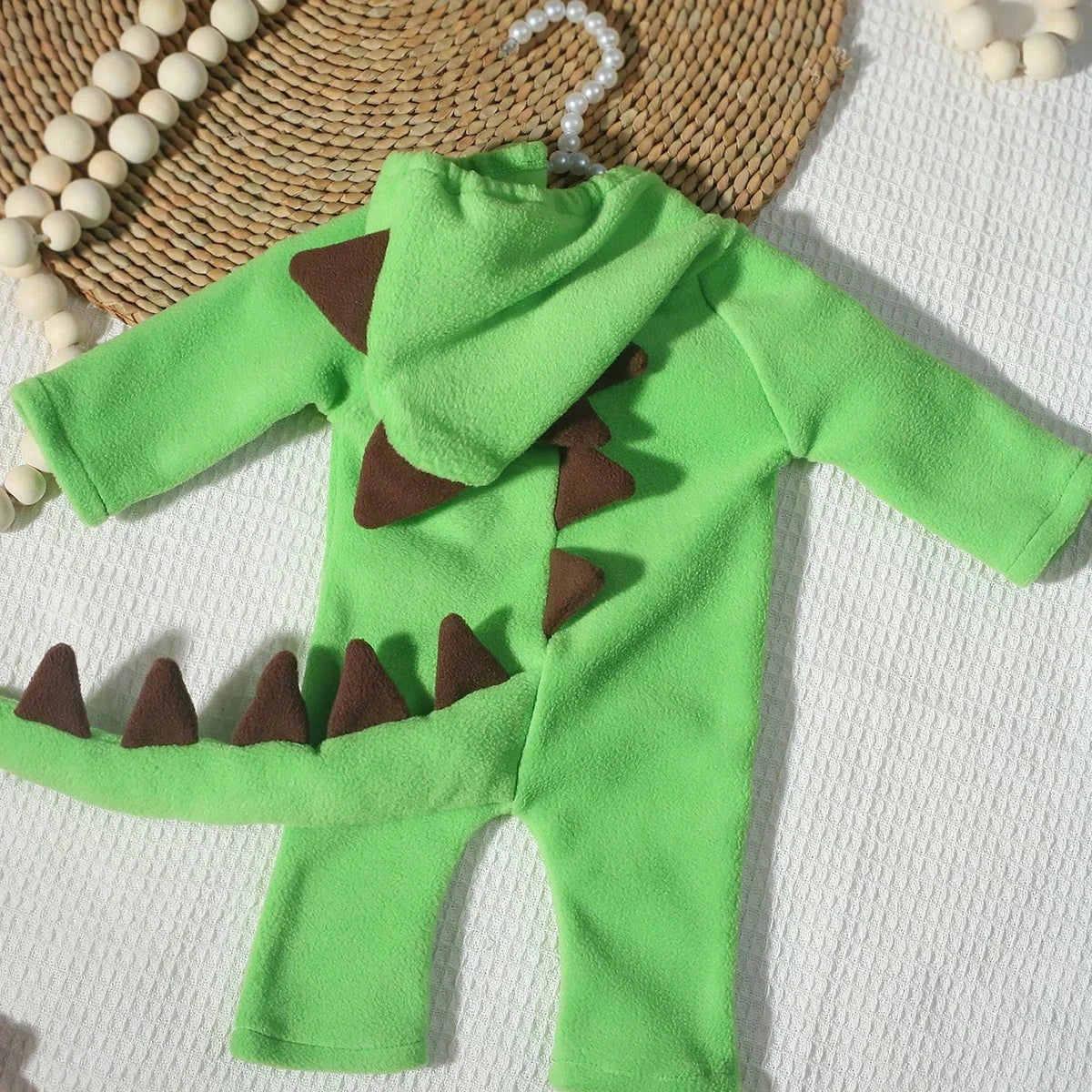 Green dinosaur costume jumpsuit with hood spikes and brown belly scales
