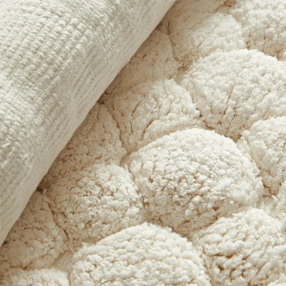 Ivory bath rug corner showing plush loop pile and thick woven backing close-up