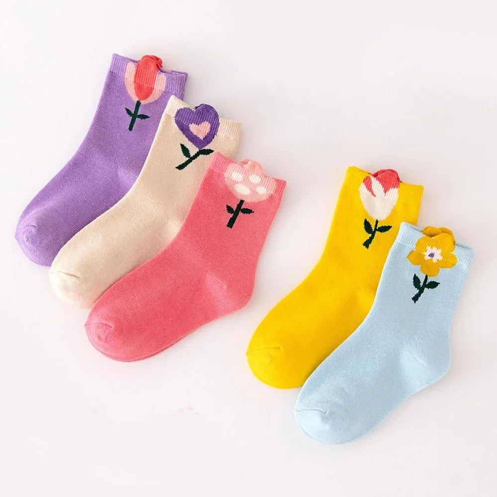 Kids crew sock set in purple, cream, pink, yellow, and light blue with flower designs