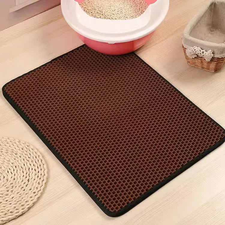 Coffee-brown cat litter mat with hex-pattern grid and dark border