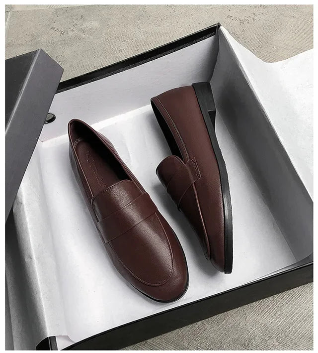Women’s dark brown leather slip-on loafers, rounded toe, low flat sole.