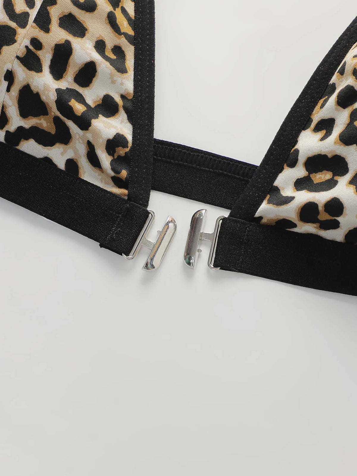 Black bralette back band with silver metal clasps and leopard print trim