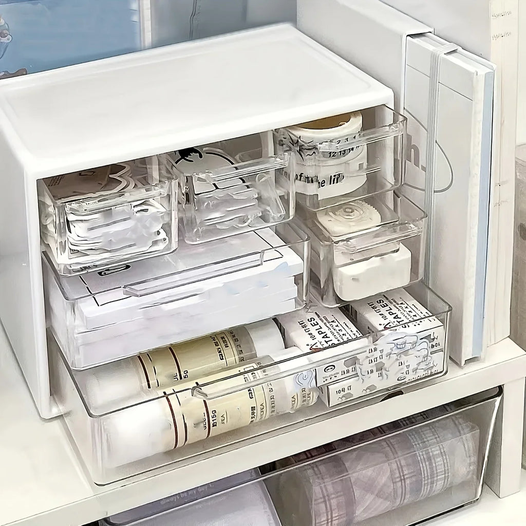 White plastic desk organizer with open drawer showing stacked compartments for office supplies