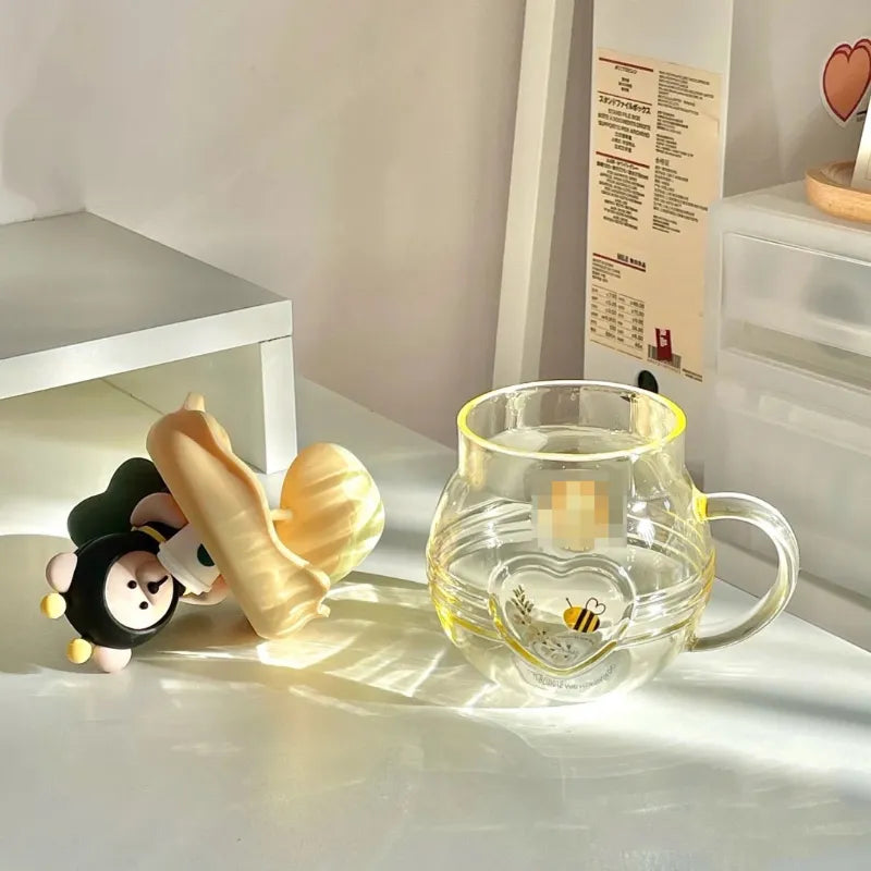 Glass tea infuser mug with bear character lid and bee decal on heart-shaped panel