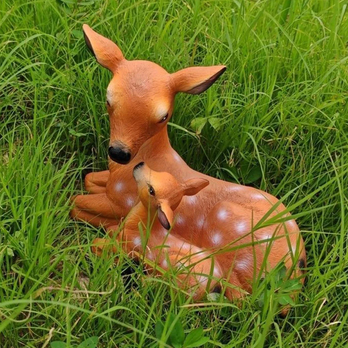 Doe and fawn deer statue set, mother and fawn resting in tall grass
