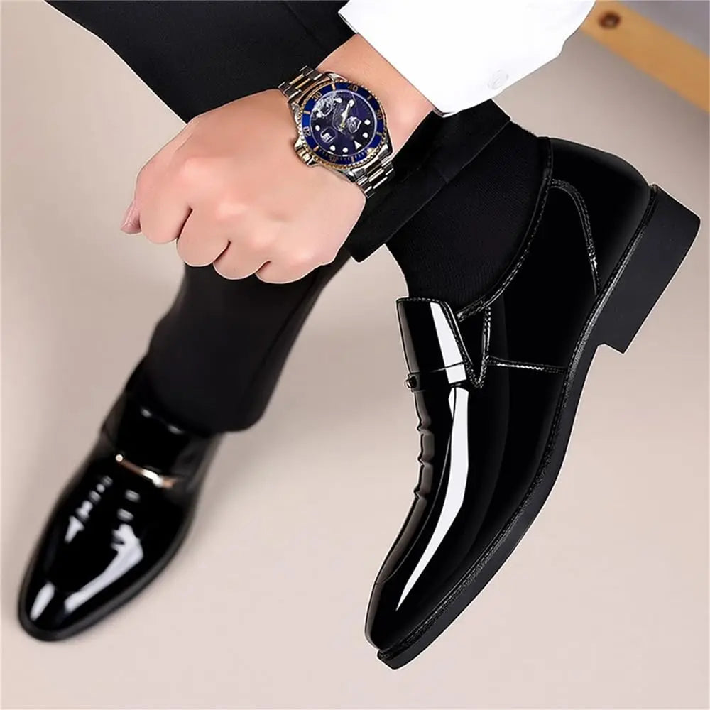 Men's black patent loafers with buckle strap and curved stitching