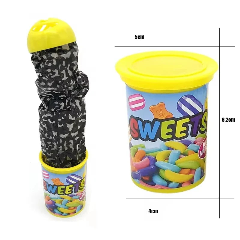 Prank toy hand emerging from candy-filled tube with yellow cap, two pieces shown