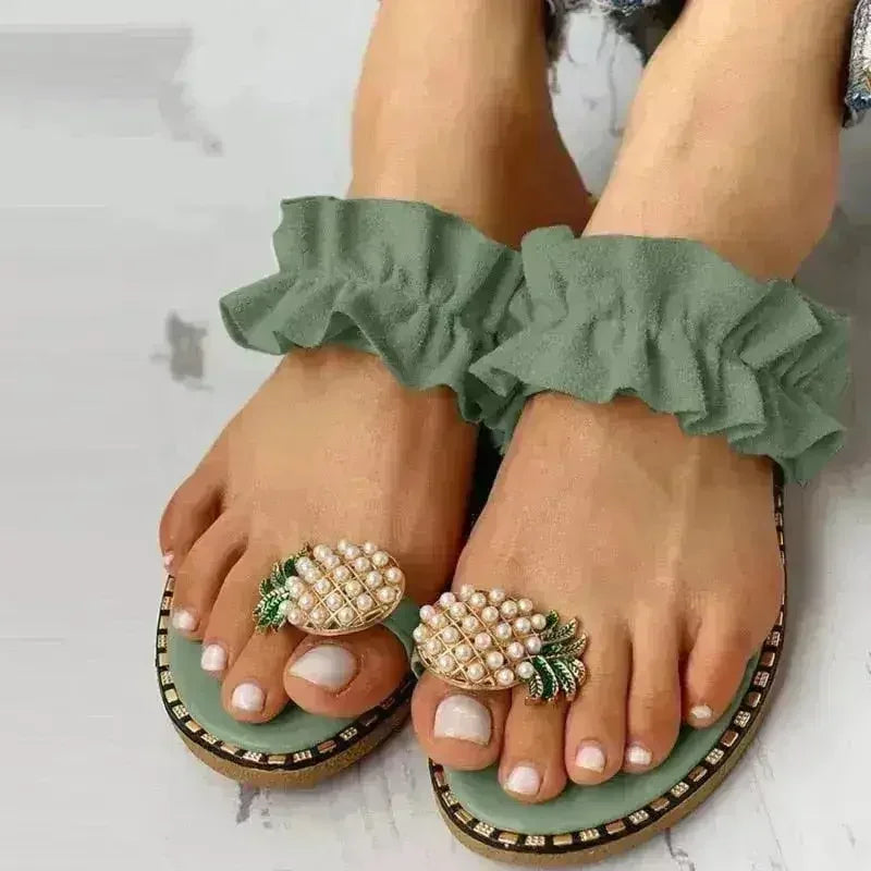Green flat slide sandals with pearl pineapple ornaments and double ruffle strap