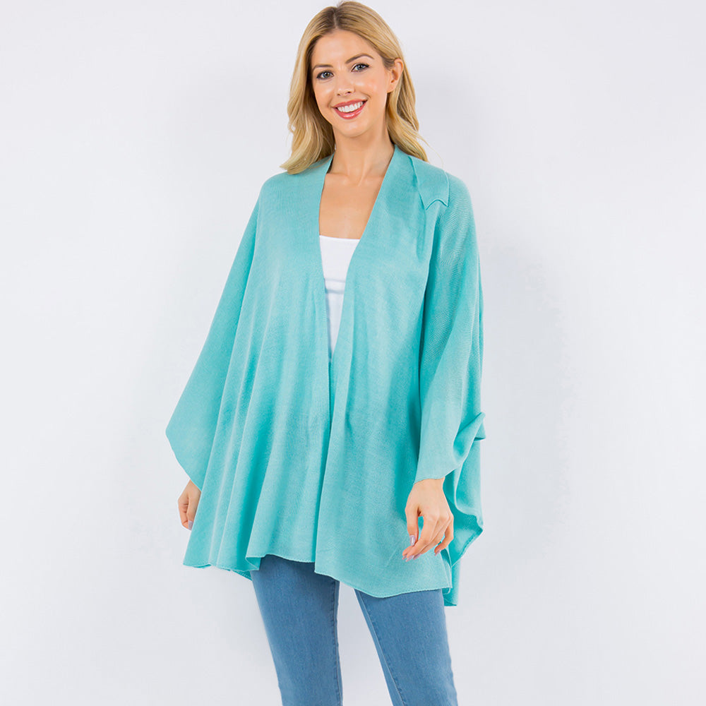 Light blue drape wrap poncho with open front and layered drape over jeans