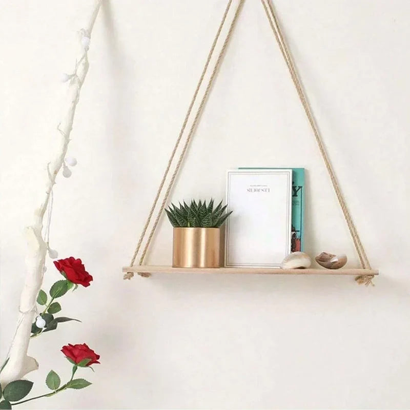 Hanging hemp-rope wooden shelf with potted plant, framed photo, and small vase