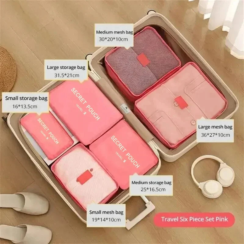 Pink waterproof packing cube set with 6 pouches in a travel organizer tray