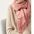 Light pink wool scarf with fringed ends, wrapped as a cozy shawl