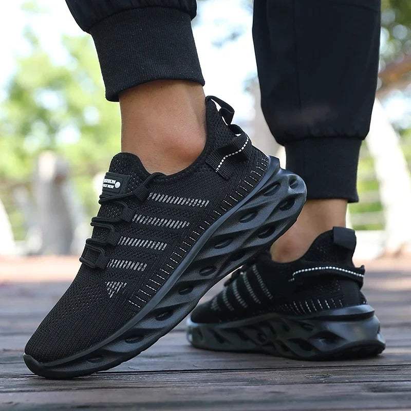 Black knit lace-up sports shoes with thick tread sole and hook-and-loop strap detail