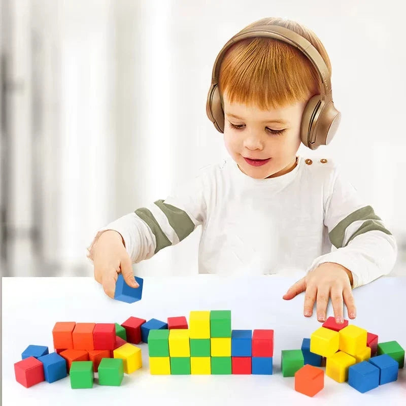 Young child playing with colorful wooden cube blocks on a floor