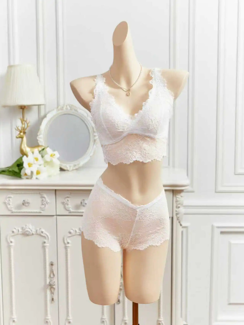 White sheer lace lingerie set on mannequin, lace cups bra with matching shorts