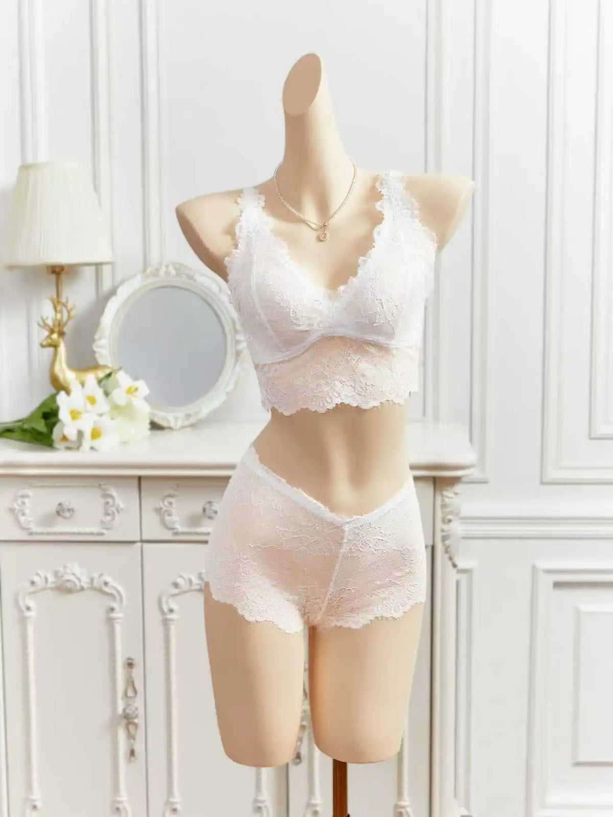 White sheer lace lingerie set on mannequin, lace cups bra with matching shorts
