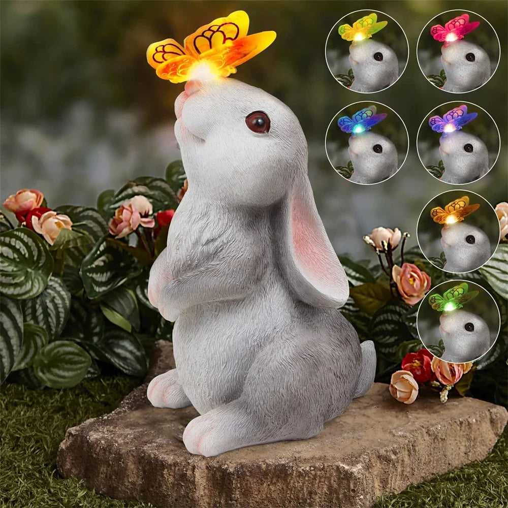 Gray bunny garden statue with colorful butterfly LED light and flower bouquet, seated