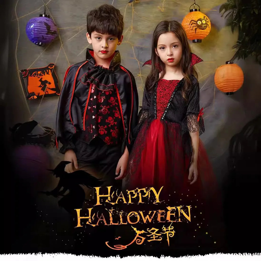 Kids vampire Halloween costumes standing together: boy black outfit, girl red dress
