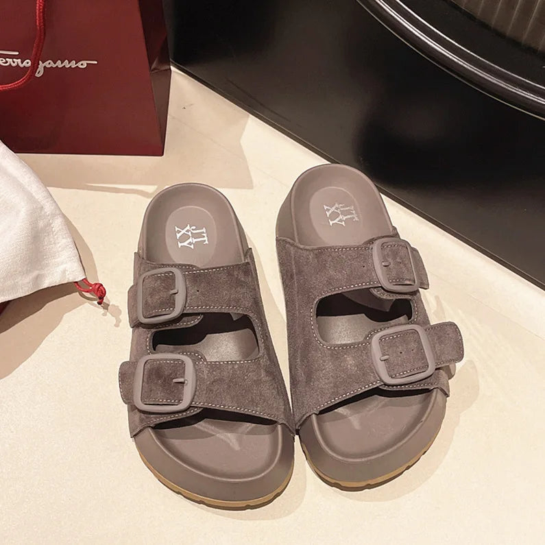 Dark gray suede platform slide sandals with two adjustable buckle straps