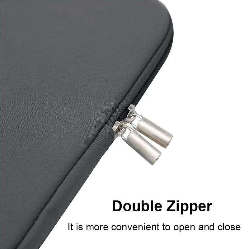 Grey padded laptop sleeve with double zipper and metal zipper pulls on edge.
