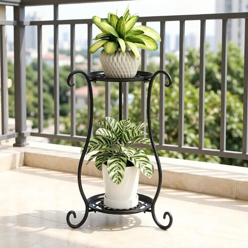 Black metal flower pot stand with curved legs and two circular tiers on patio