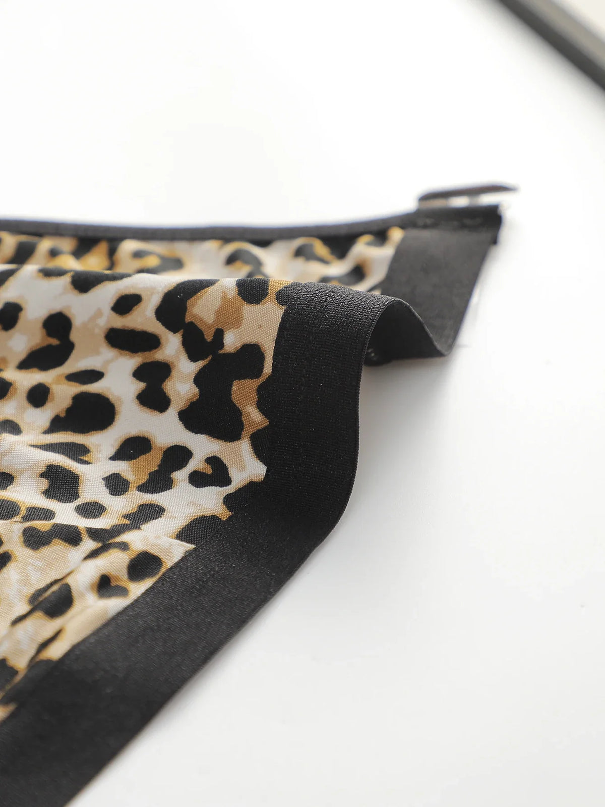 Leopard print triangle bralette fabric with black edge trim detail