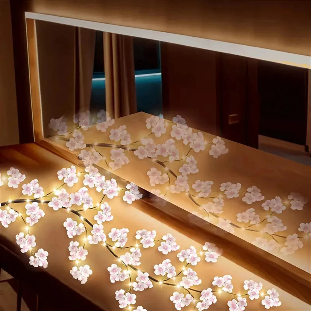 Cherry blossom LED lights strung along staircase railing, warm white pink blooms