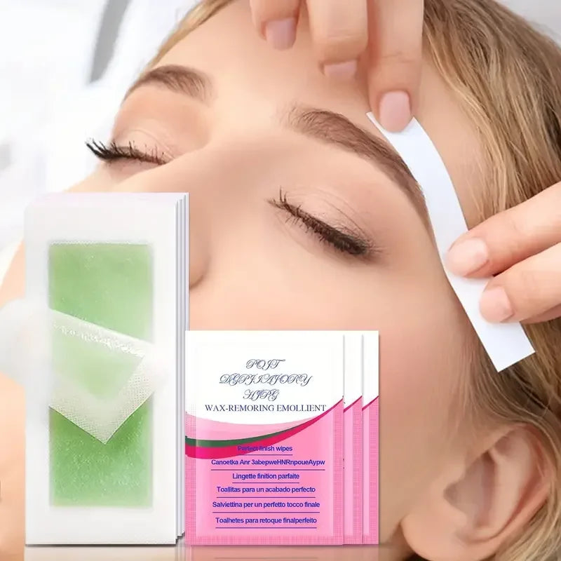 Cold wax hair removal strips with green wax papers and wax-removing emollient wipe.