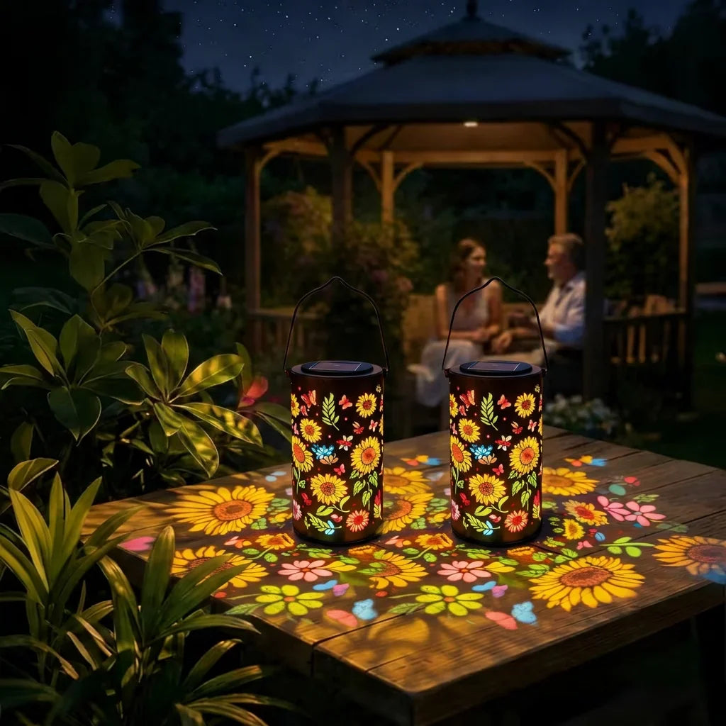Two hanging sunflower solar lanterns with black lids on outdoor table, glowing garden light