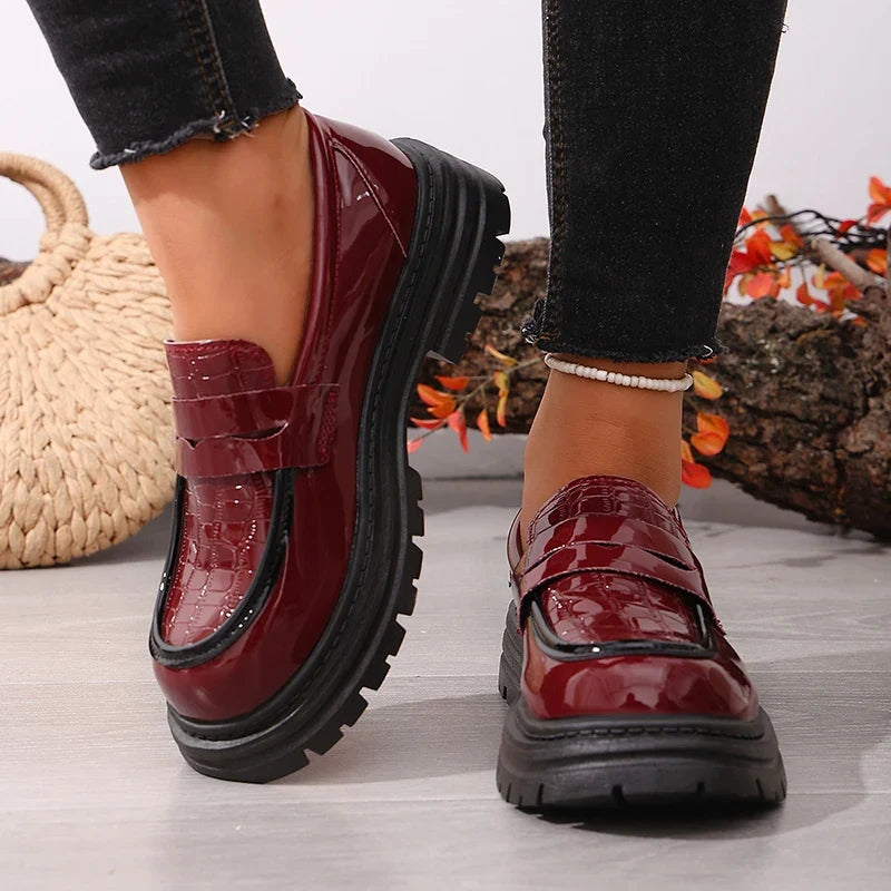 Red patent leather slip-on loafers with rounded toe and chunky platform sole