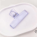 Translucent light purple jelly binder clip with spring hinge for organizing papers