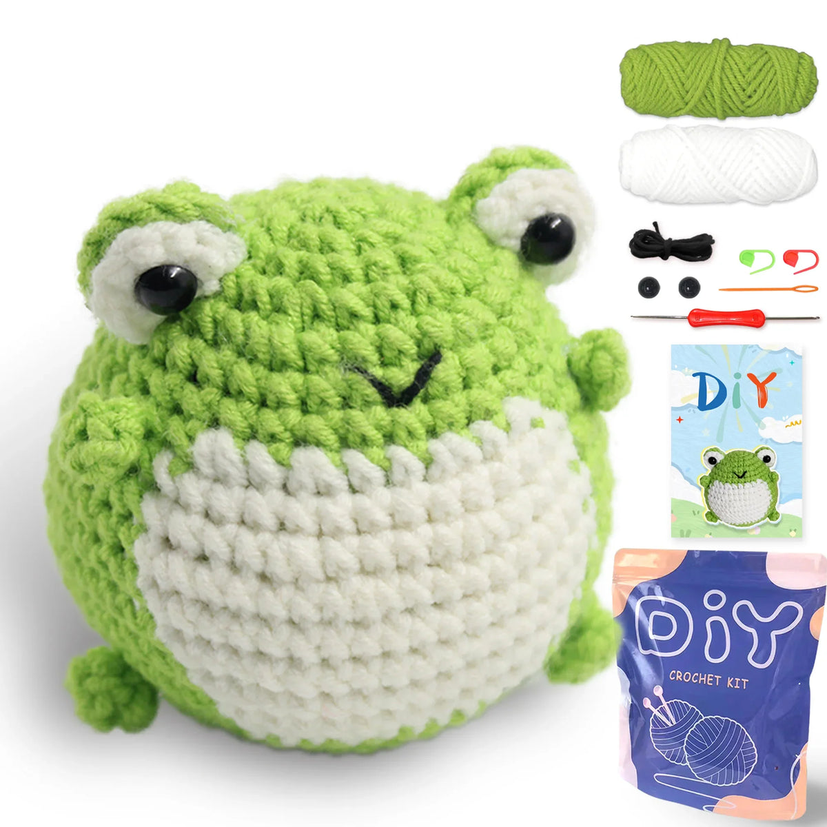 Crochet animal toy kit with green frog plush, white belly, yarn balls, and hook