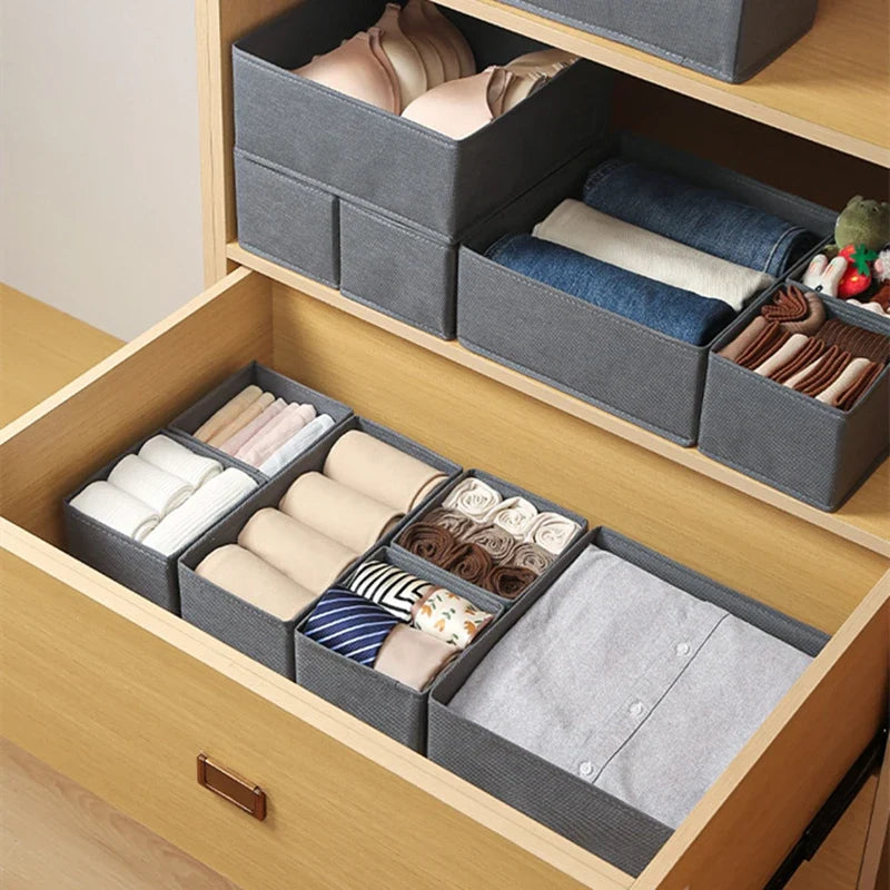 Gray foldable storage bins in a wooden drawer for underwear, bras, socks and belts