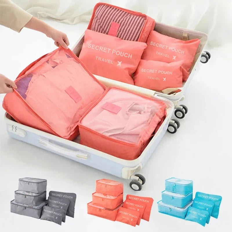 Waterproof packing cube set with 6 coral pink pouches in a clear zipper case